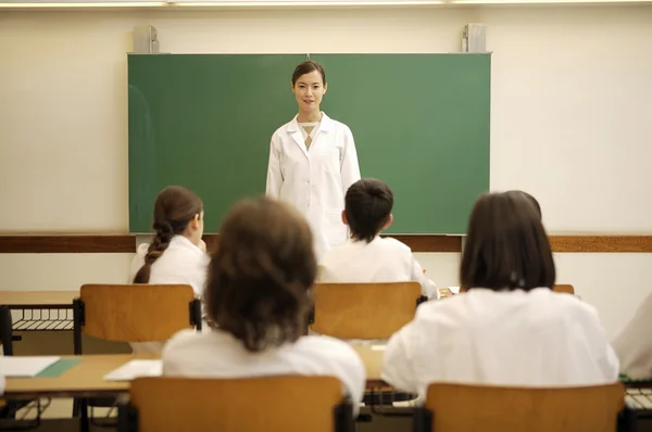 Young teacher in classroom — Stock Photo, Image