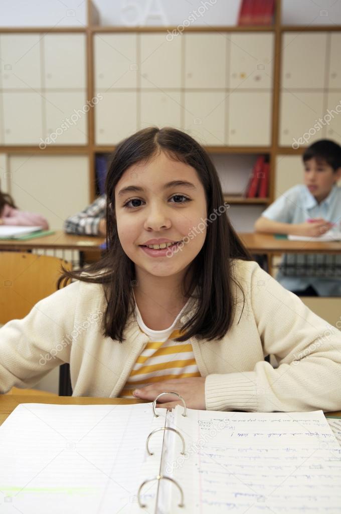 School girl sitting by the desk