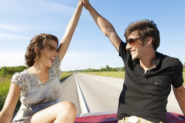 young couple sitting in back seat