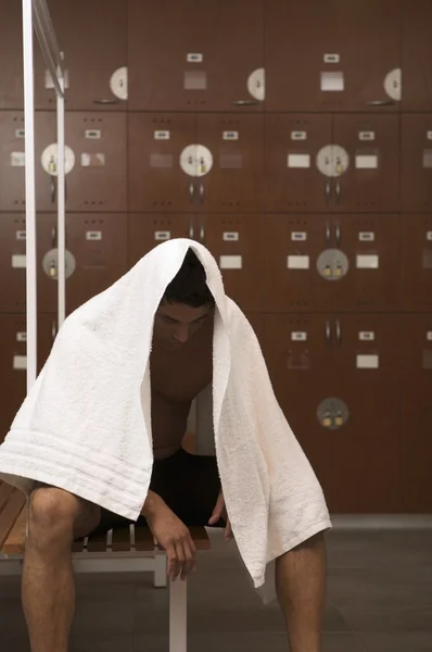 man resting in locker room