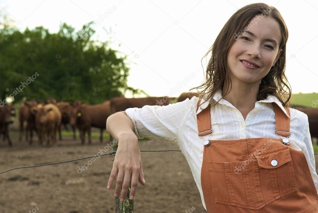 young woman against herd of bulls