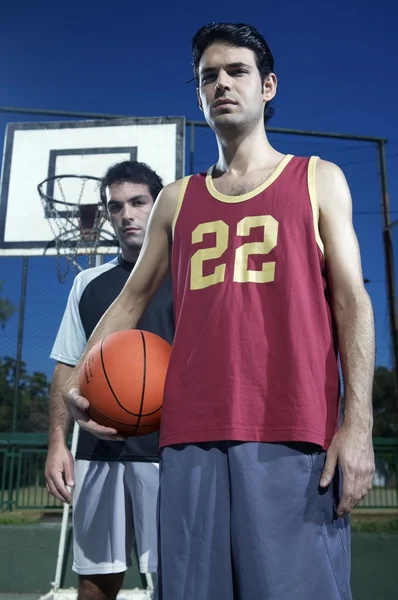 young men standing on court