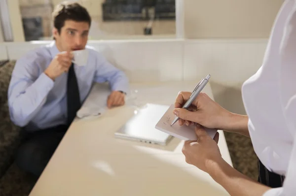 waitress hands writing order