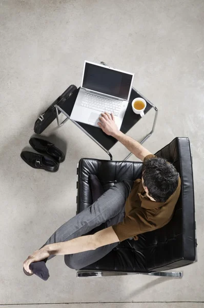 Businessman practicing yoga at office