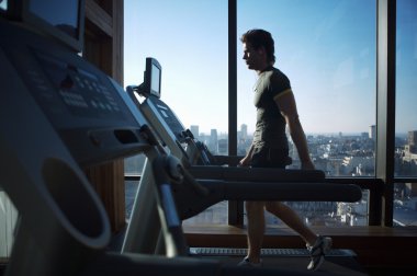 Koşu bandı üzerinde çalışan genç adam