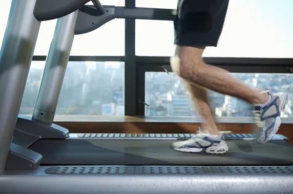 Male legs running on treadmill — Stock Photo, Image