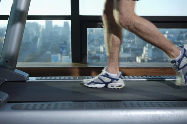 Male legs running on treadmill — Stockfoto
