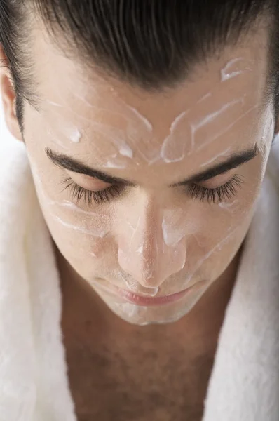 Man with lotion on his face — Stock Photo, Image