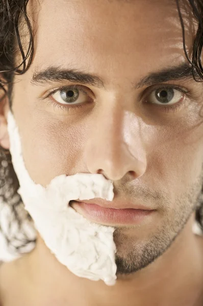 Man with shaving cream on half his face — Stock Photo, Image