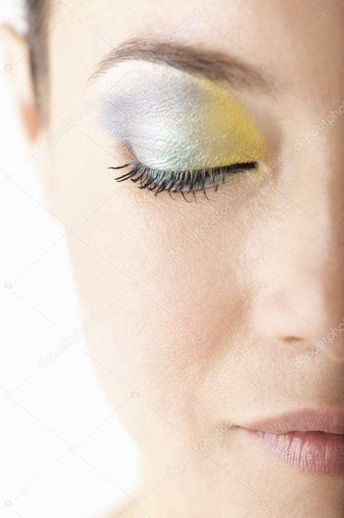 woman wearing blue and yellow eyeshadow