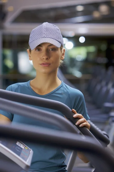 Woman standing near treadmill — Stock Photo, Image