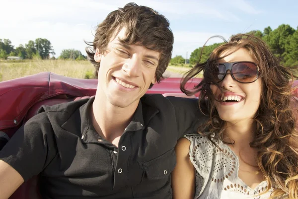 young couple sitting in back seat