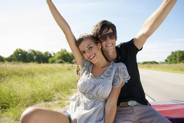 young couple sitting in back seat