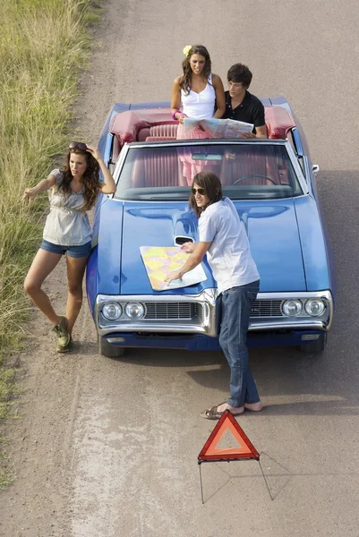 couples on car stopped on side of road