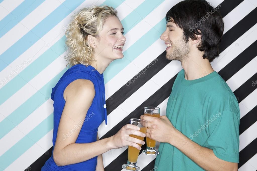 teenage couple holding beverages