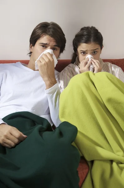Sick couple on couch — Stock Photo, Image