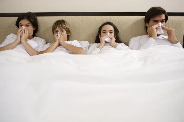 Sick family blowing noses — Stock Photo, Image