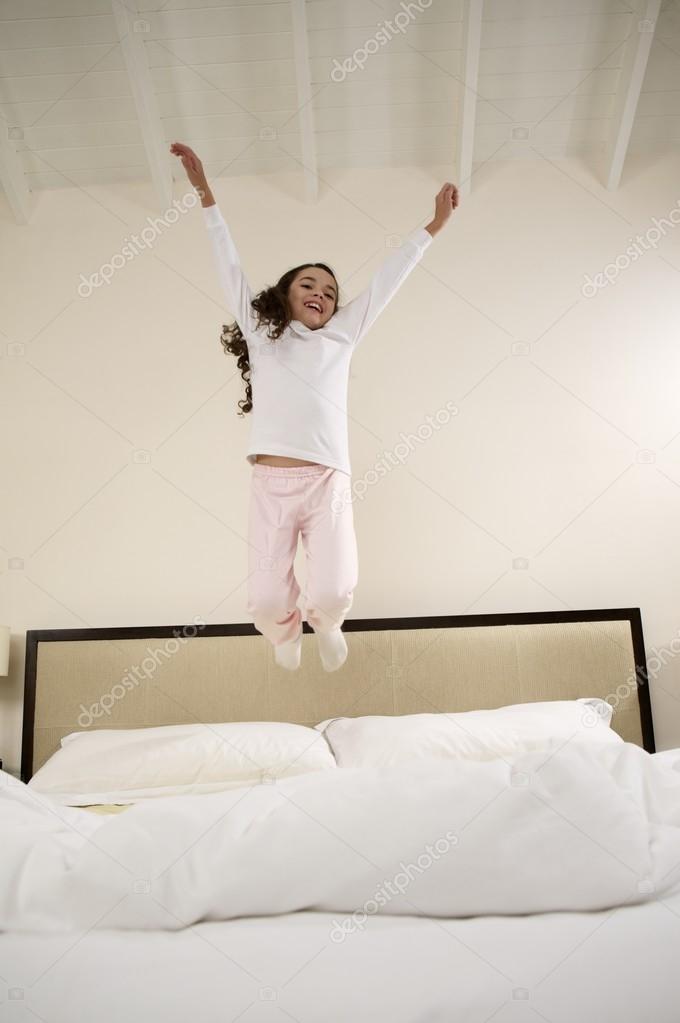 Little girl jumping on bed — Stock Photo © Focusarg 94115610