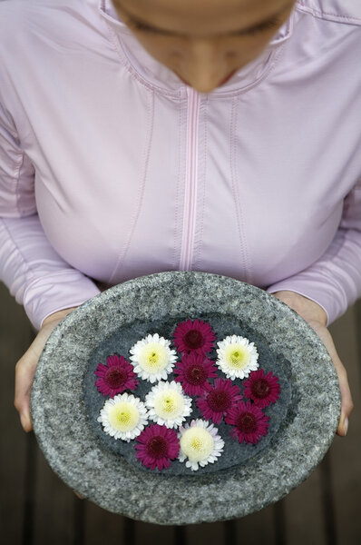 Woman holding flower dish