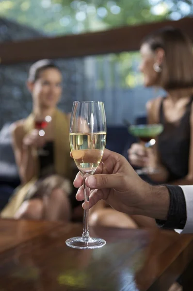 Male hand holding glass of champagne — Stock Photo, Image