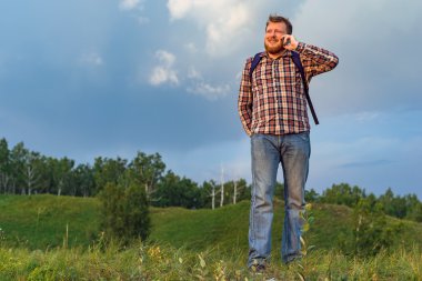 Telefonda konuşurken bir sırt çantası ile turizm