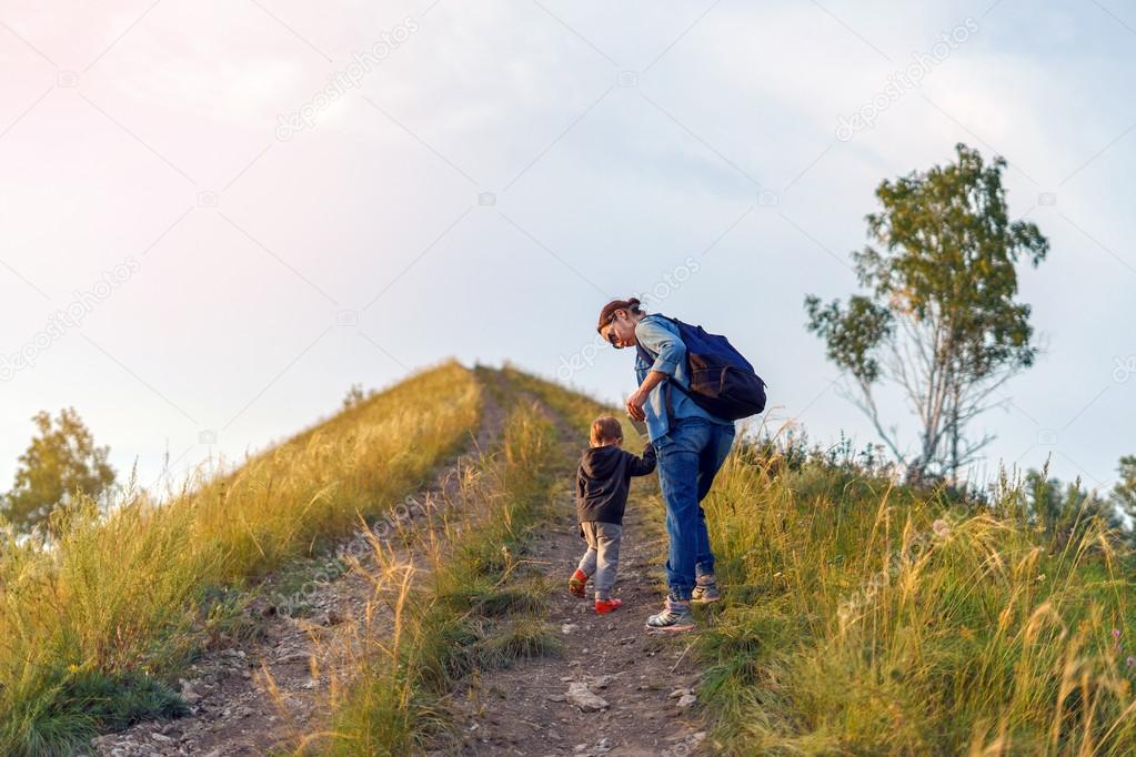 хайкинг в горах. человек поднимается на холм. человек на высоком холме. тропинка в горах. человек взбирается на холм.