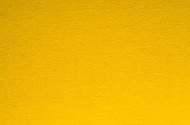Küçük öbekli kumaştan yapılmış koyu sarı arkaplan.