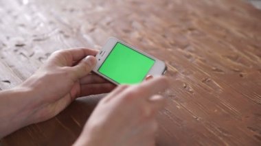 Akıllı telefon üzerinde ahşap masa kullanarak çeşitli el jestleri, dikey