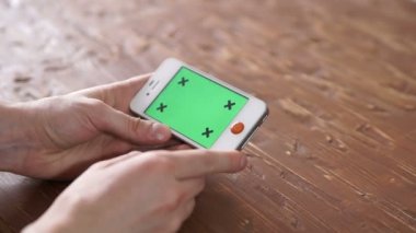 Akıllı telefon üzerinde ahşap masa kullanarak çeşitli el jestleri, dikey