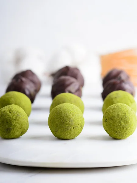 Dates truffles with dark chocolate and matcha — Stock Photo, Image