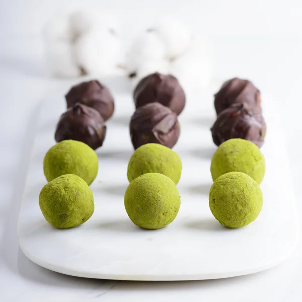 Dates truffles with dark chocolate and matcha — Stock Photo, Image