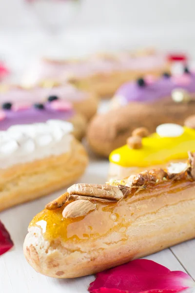 Eclairs with colored cream — Stock Photo, Image