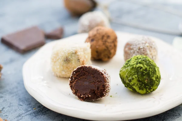 Chocolate truffles on white dish — Stock Photo, Image