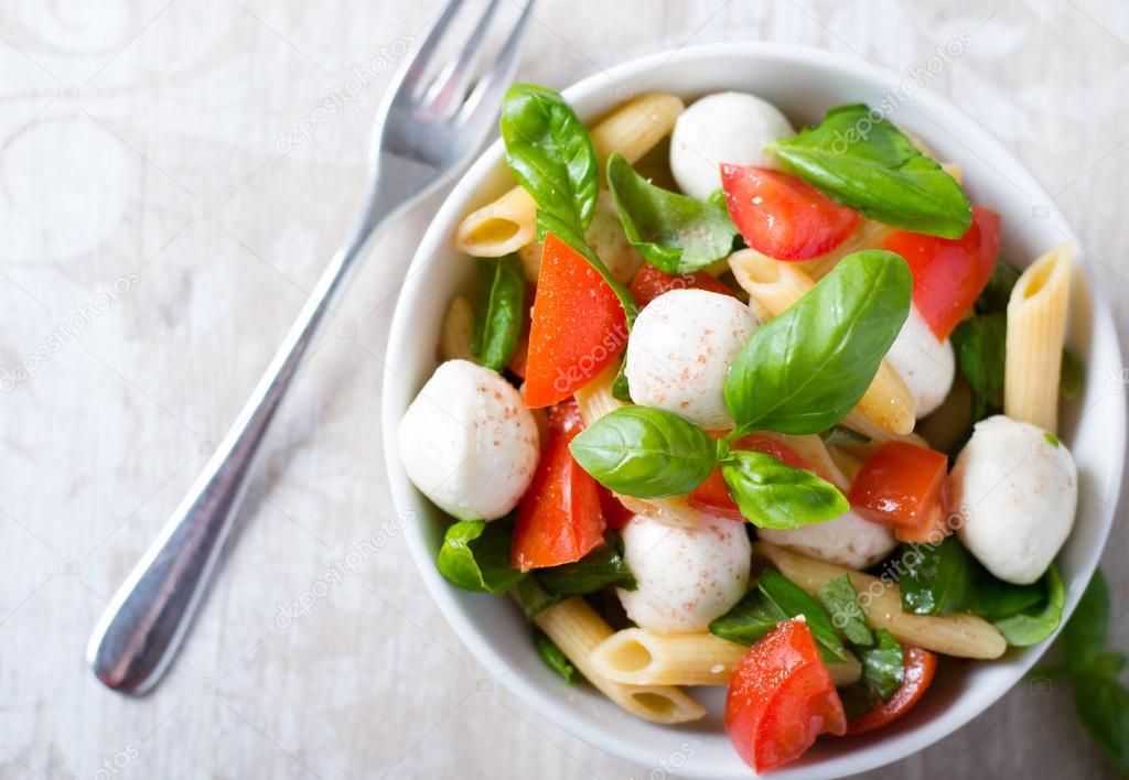 Salad with pasta in white bowl