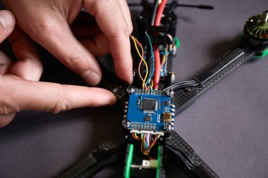 İnsan ellerinin parçaları kullanarak insansız hava aracını bir araya getirmesini araçları kullanarak, yüksek hızda yarışan kuadkopteri uçuş için hazırlamasını istiyorum. Eğitim sürecinden önce İHA 'yı onar.