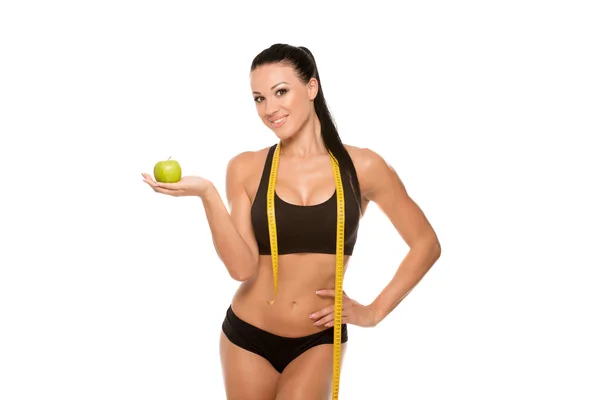 Güzel fitness modeli apple ve ölçüm bandı ile