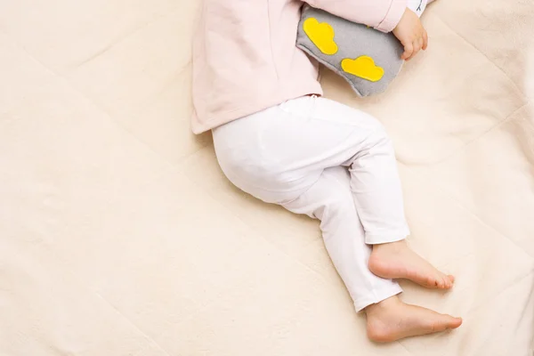 Μικρά όμορφα πόδια του ένα μωρό κορίτσι παιδί στον ύπνο με μια κουκουβάγια παιχνίδι — Φωτογραφία Αρχείου