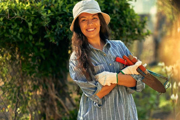 Sorrindo Jovem Dona Entre Suas Plantas Com Braços Dobrados Uma — Fotografia de Stock