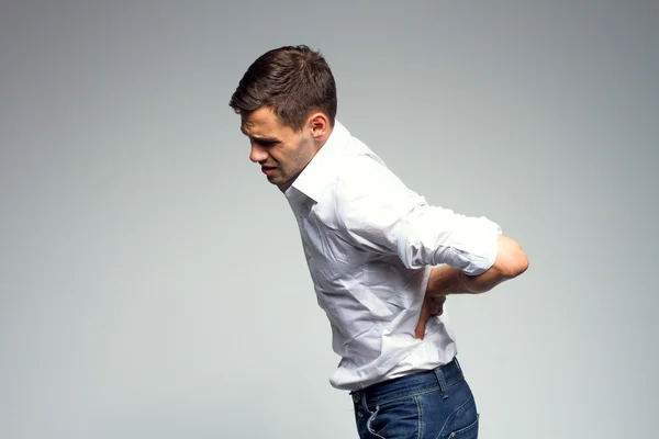 Businessman holding his lower back in pain — Stock Photo, Image