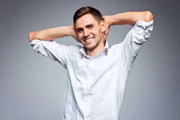 Portrait of young happy smiling business man, isolated over gray background — Stock Photo, Image