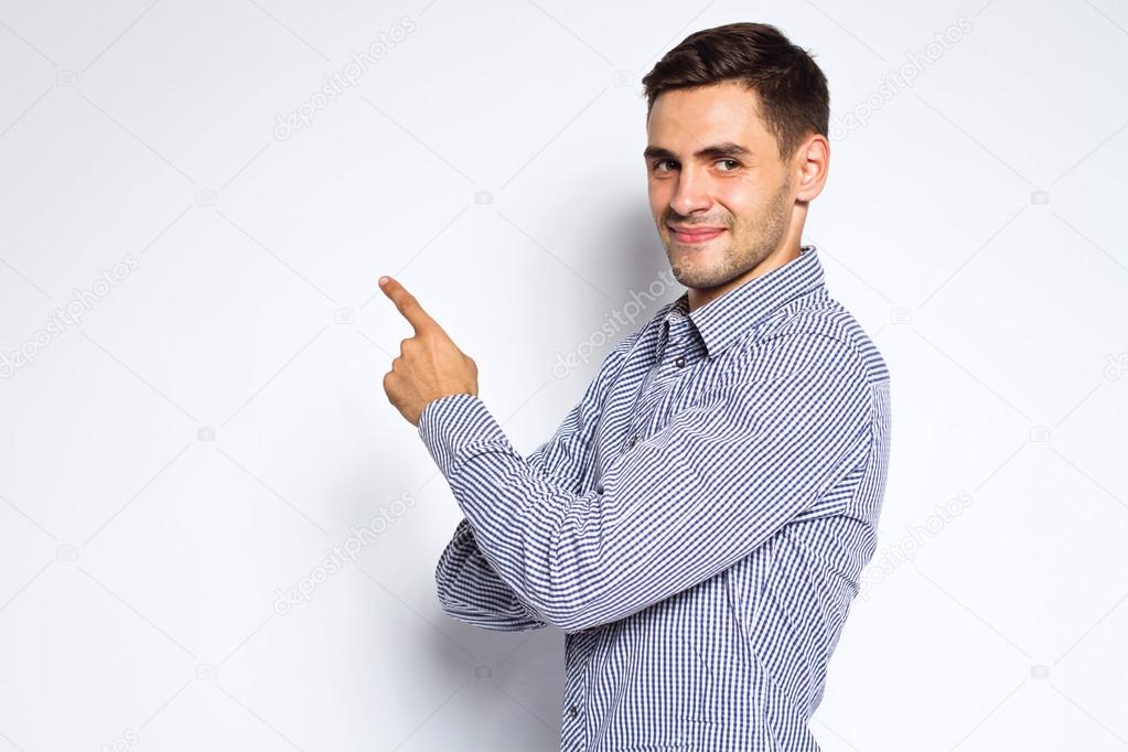 Portrait of young business man posing on gray background