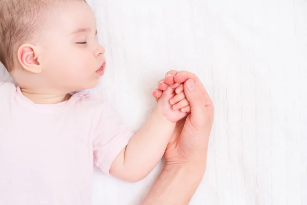 Όμορφο μωρό στον ύπνο με τη μαμά χέρι σε άσπρο φόντο — Φωτογραφία Αρχείου