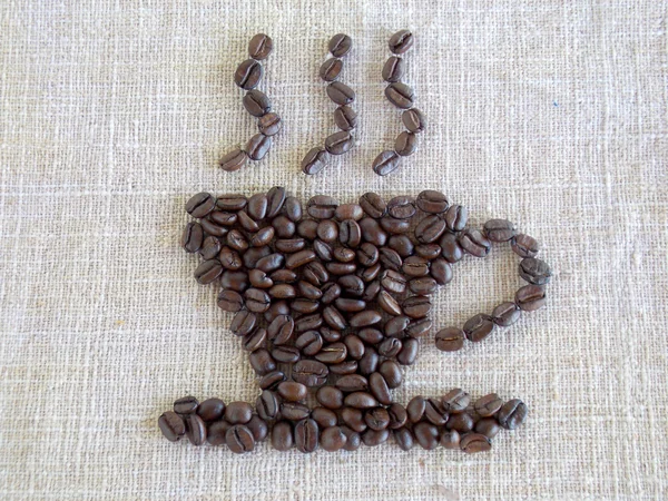Çul arka plan üzerinde kahverengi kahve çekirdekleri — Stok fotoğraf