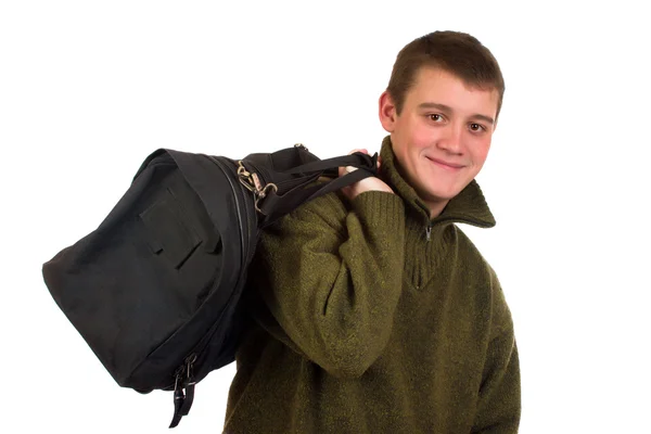 Młody człowiek w sweter i torba podróżna na ramionach — Zdjęcie stockowe