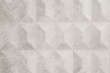 Bu desenli duvar, modern ve şık bir görünüm yaratarak elmas şekillerinin tekrarlayan bir kalıbını içeriyor.