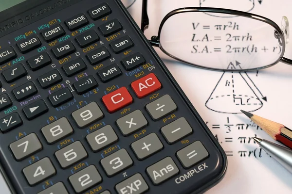 Eye Glasses, pen and pencil over the Formula with calculator — Stock Photo, Image