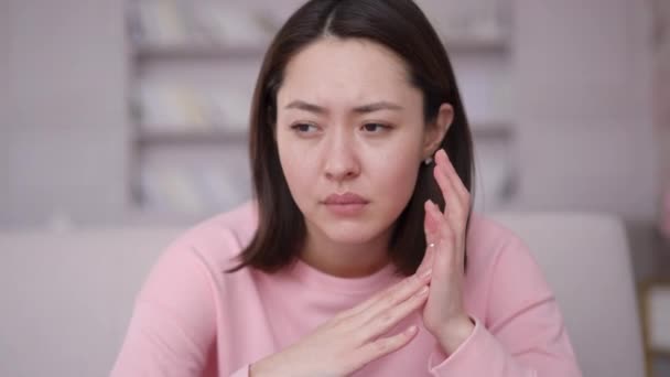 Sad depressed young asian woman feeling bad stressed worried anxious ashamed, upset nervous multi ethnic girl having problem regret unwanted pregnancy need psychological help sitting alone at home — Stock Video