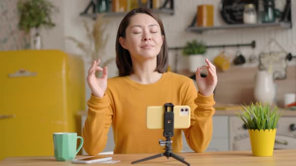 Mindful calm beautiful mixed race female blogger making video lessons and tutorials for internet vlog website classes sit at sofa doing yoga adem oefening mediteren thuis, harmonie en evenwicht staat — Stockvideo