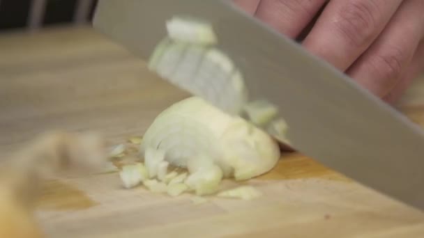 Chef cutting up an onion with a knife — Stock Video