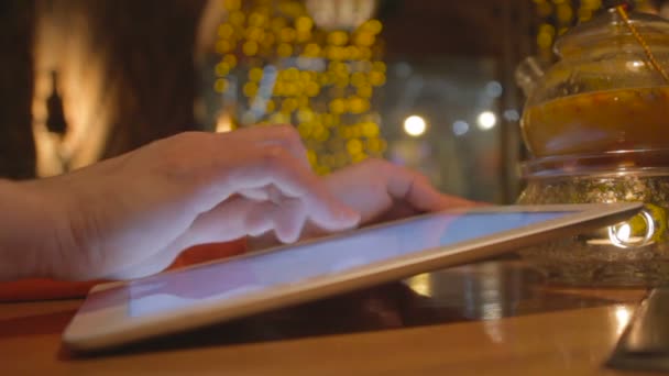 Człowiek przy użyciu komputera typu tablet pc i picia kawy w kawiarni. — Wideo stockowe